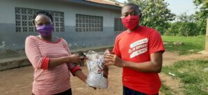Olugbenga and one of his peers with a set of donated, COVID-19 masks
