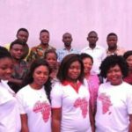 Group of women standing in front of group of men